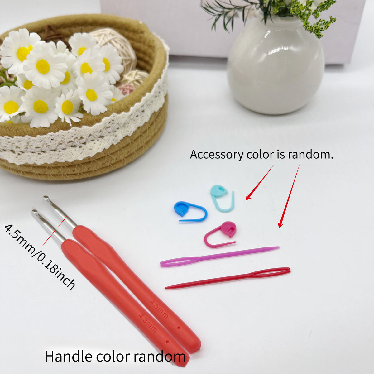 A set of red crochet hooks with stitch markers and needles is displayed next to a woven basket and white ceramic vase.