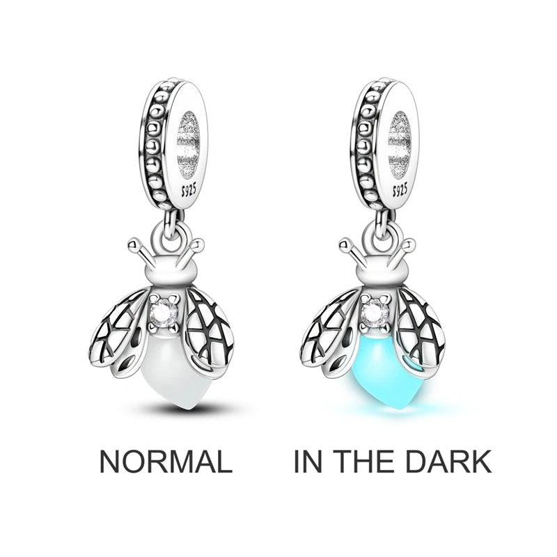 Sterling silver charm beads shaped like bees shown in normal light and in the dark.