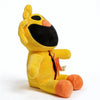 A yellow and black plush doll resembling a cat with large ears and an orange nose.