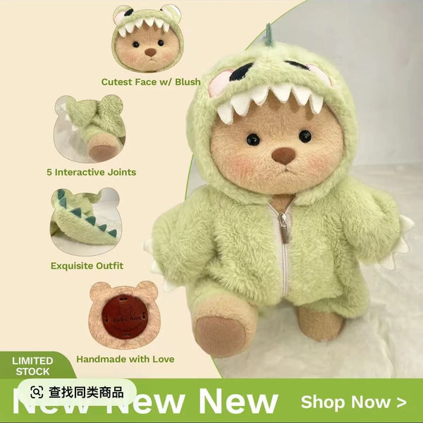 A soft green bear doll dressed in a dinosaur jumpsuit outfit with large teeth and a hood.