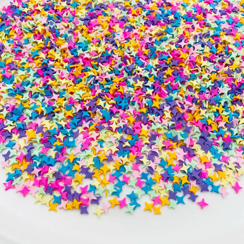 A pile of colorful polymer clay star and heart sprinkles in various bright colors.