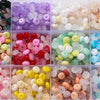 A collection of 6mm imitation jade glass spacer beads in various colors including purple, pink, yellow, green, and clear.