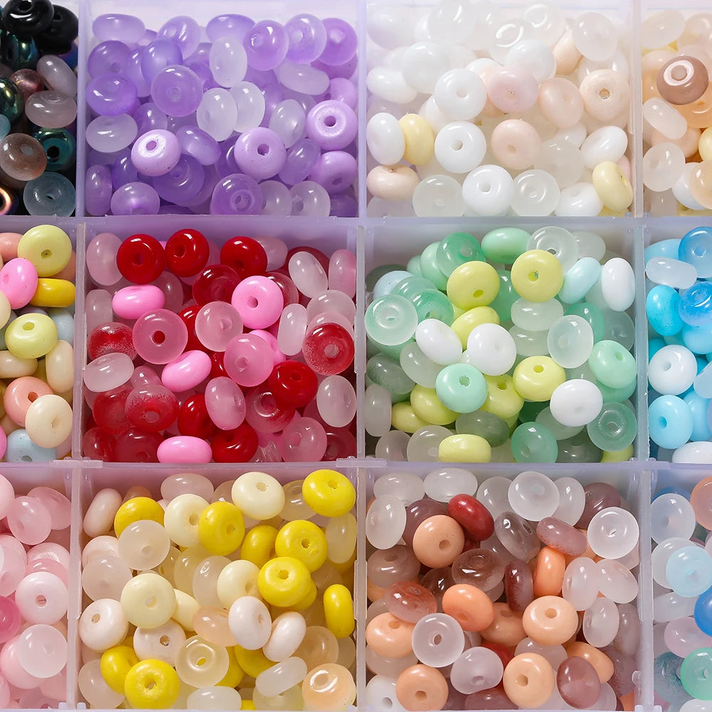 A collection of 6mm imitation jade glass spacer beads in various colors including purple, pink, yellow, green, and clear.