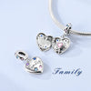 Silver heart charm bead with pink zircon set on a silver chain.