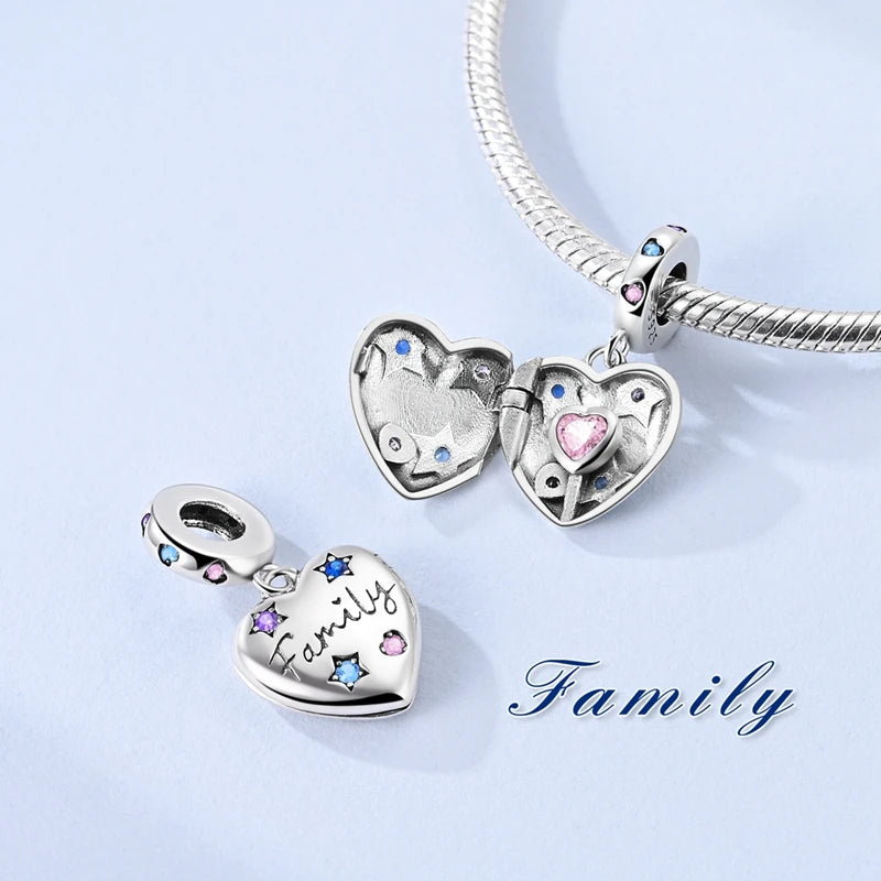 Silver heart charm bead with pink zircon set on a silver chain.