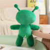 An adorable green alien plush toy with long ears sitting on a light green surface.