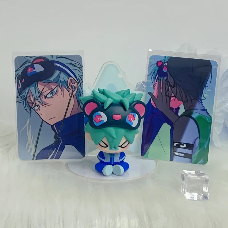 A blind box featuring a cute green and blue character figure with accessories and packaging.