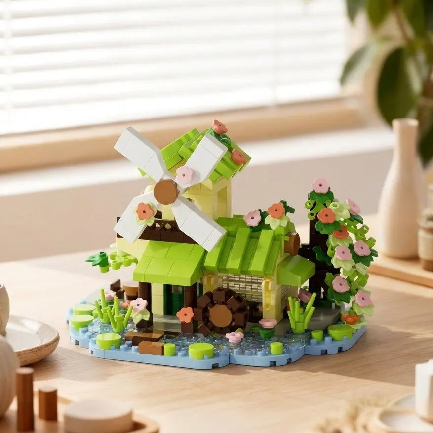 A miniature forest cabin building block set featuring a green greenhouse, wooden structure, and a windmill on a light wood su