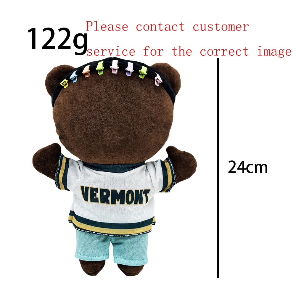 A brown plush doll dressed in a Vermont shirt and light blue pants.