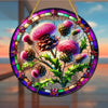 A round acrylic window hanging featuring a detailed Scottish thistle design with vibrant pink and purple flowers.