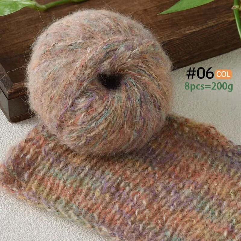 A ball of soft, fuzzy, pinkish-brown alpaca blend yarn next to a knitted scarf.