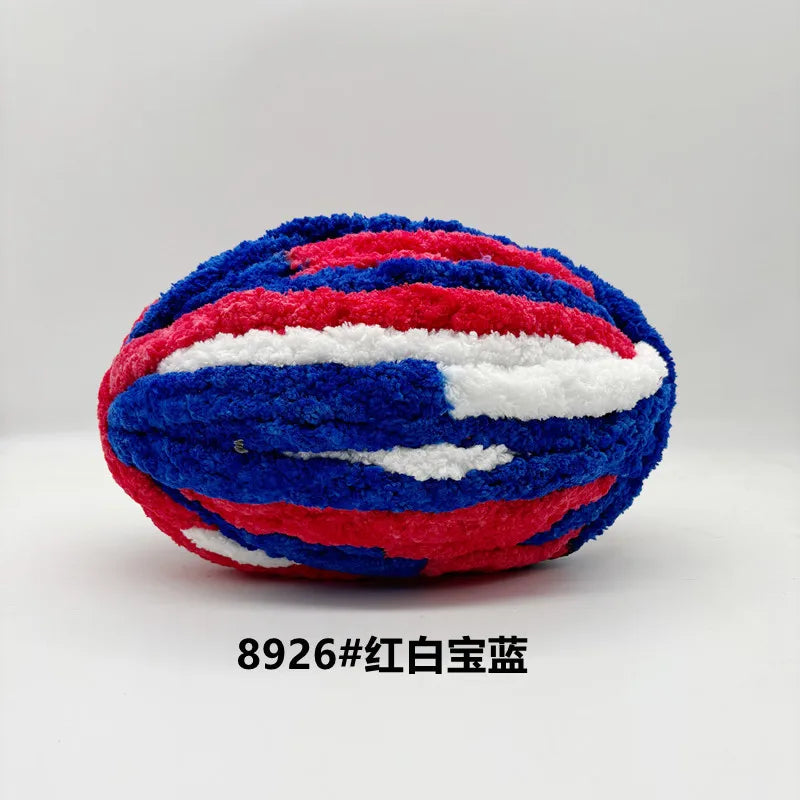 A ball of chunky red, white, and blue chenille yarn for hand knitting projects.