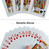 A hand holds a fan of waterproof plastic playing cards showing various face cards and aces.