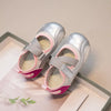 A pair of silver and pink girls' casual slip-on shoes with a breathable PU upper displayed on a light background.