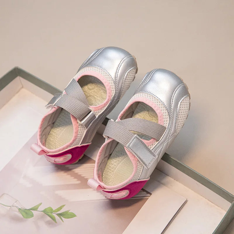 A pair of silver and pink girls' casual slip-on shoes with a breathable PU upper displayed on a light background.