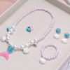 A set of five mermaid pearl jewelry pieces featuring pink, blue, and white pearls and shells.