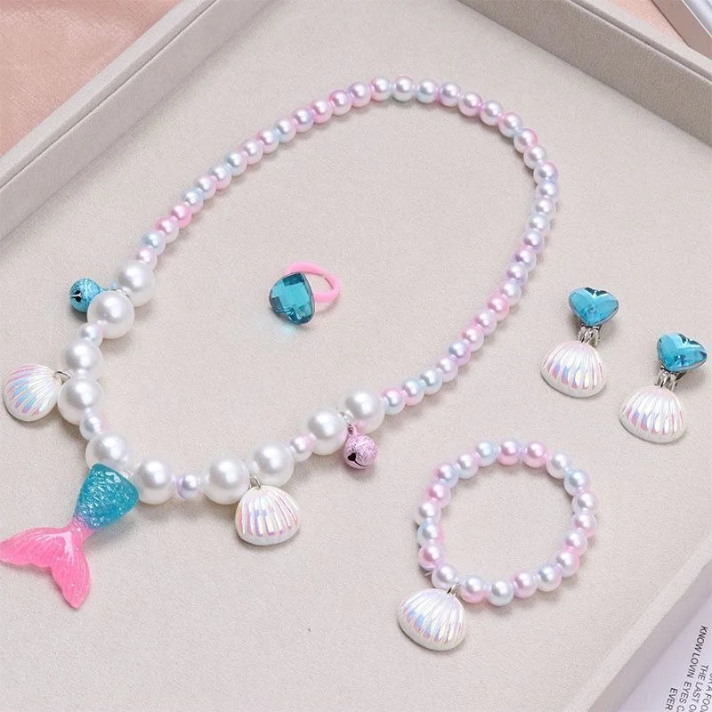 A set of five mermaid pearl jewelry pieces featuring pink, blue, and white pearls and shells.