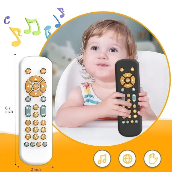 A baby is holding a black musical sensory remote control toy with various buttons and a white remote nearby.