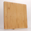 A light wood bamboo crochet blocking board with numerous small pins and a stand.