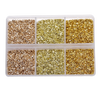 Four compartments of crushed glass stones in various shades including beige, light green, and gold.