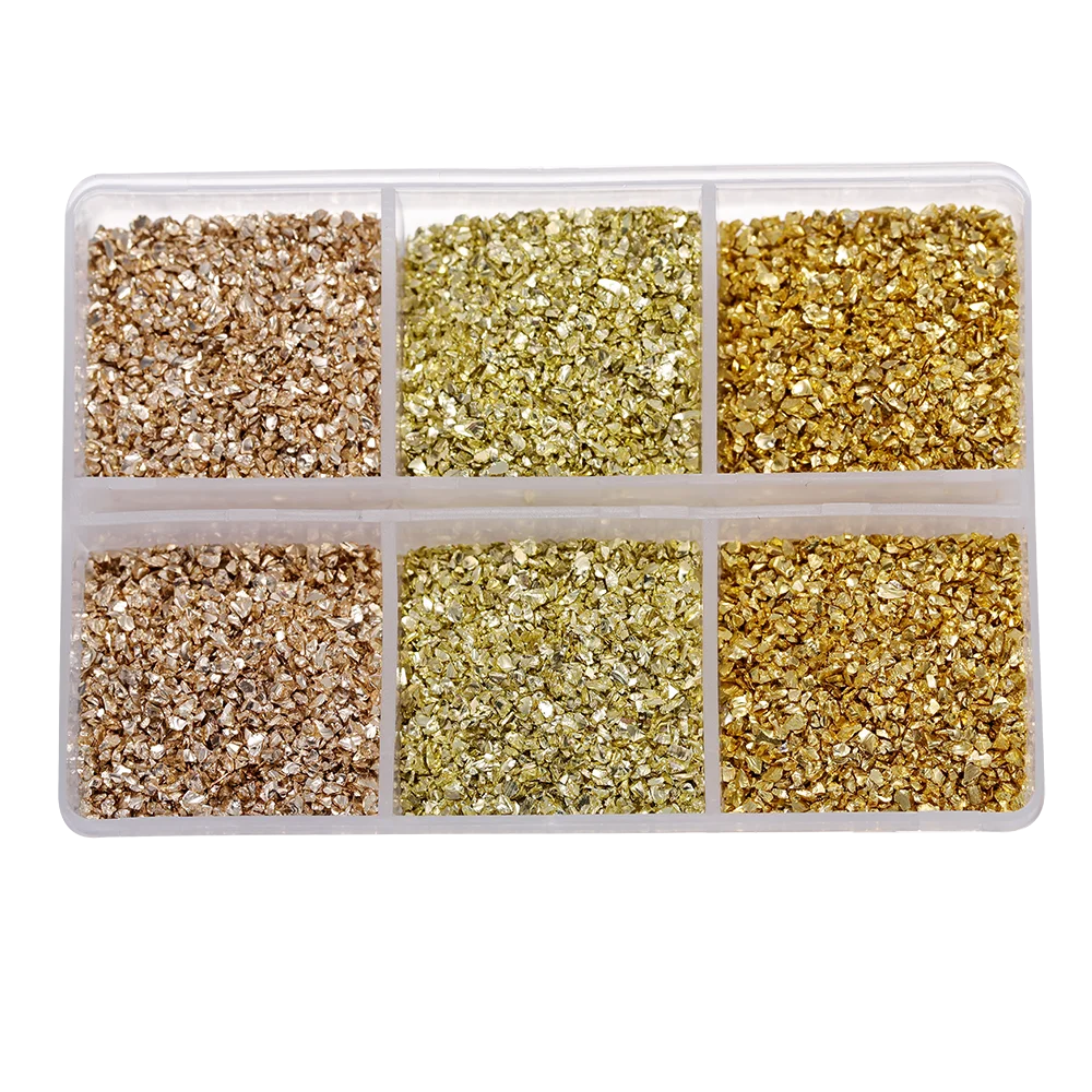 Four compartments of crushed glass stones in various shades including beige, light green, and gold.
