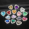 A collection of heart-shaped flatback sew-on rhinestones in various colors and clear stones.