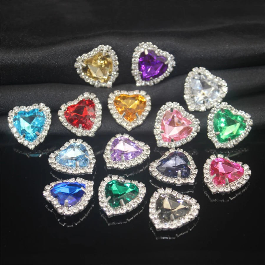 A collection of heart-shaped flatback sew-on rhinestones in various colors and clear stones.