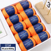 A box containing ten balls of orange merino wool yarn labeled YEDAN MERIN WORSTED WOOL THREAD
