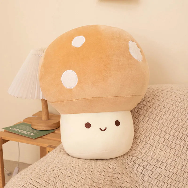 A soft, round, tan mushroom plush pillow with white spots rests on a beige textured fabric.