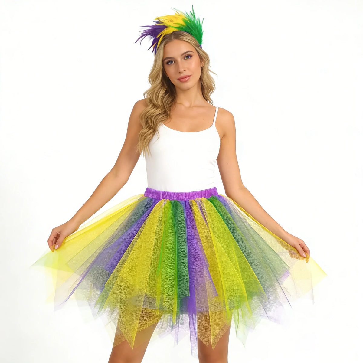 A woman models a rainbow tulle tutu skirt and feather headband set in various bright colors.