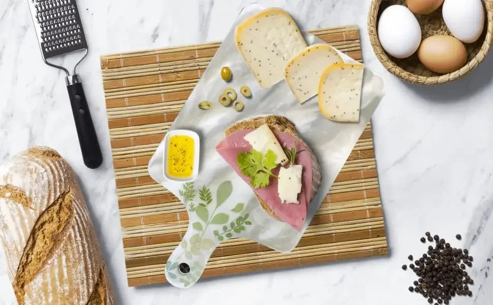 A silicone resin casting mold set is displayed on a cutting board with eggs, herbs, and a pestle.