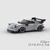 A gray and white classic rally car building block set with a black roof and racing wheels.
