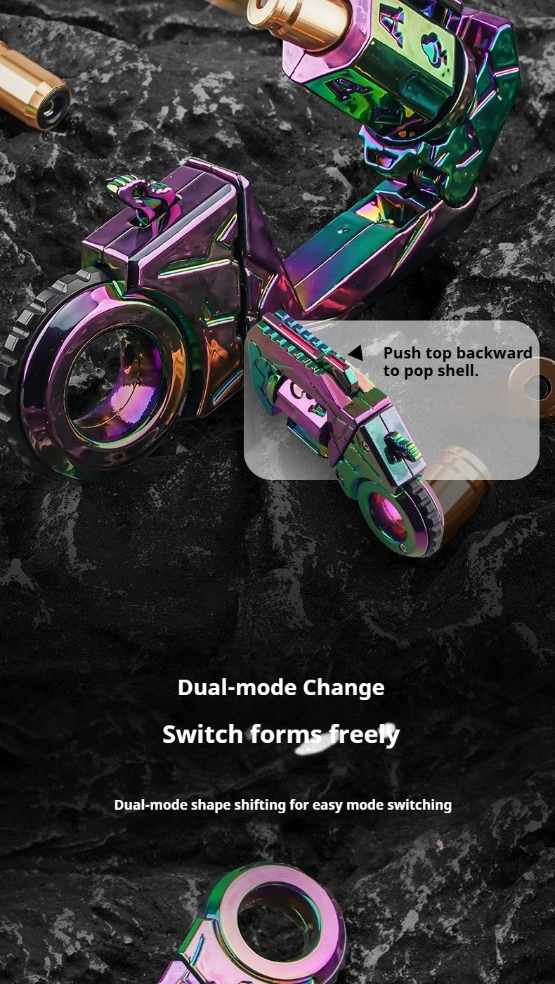 A close-up of a dual-mode metal gun-shaped fidget slider in iridescent purple and green colors resting on a dark surface.