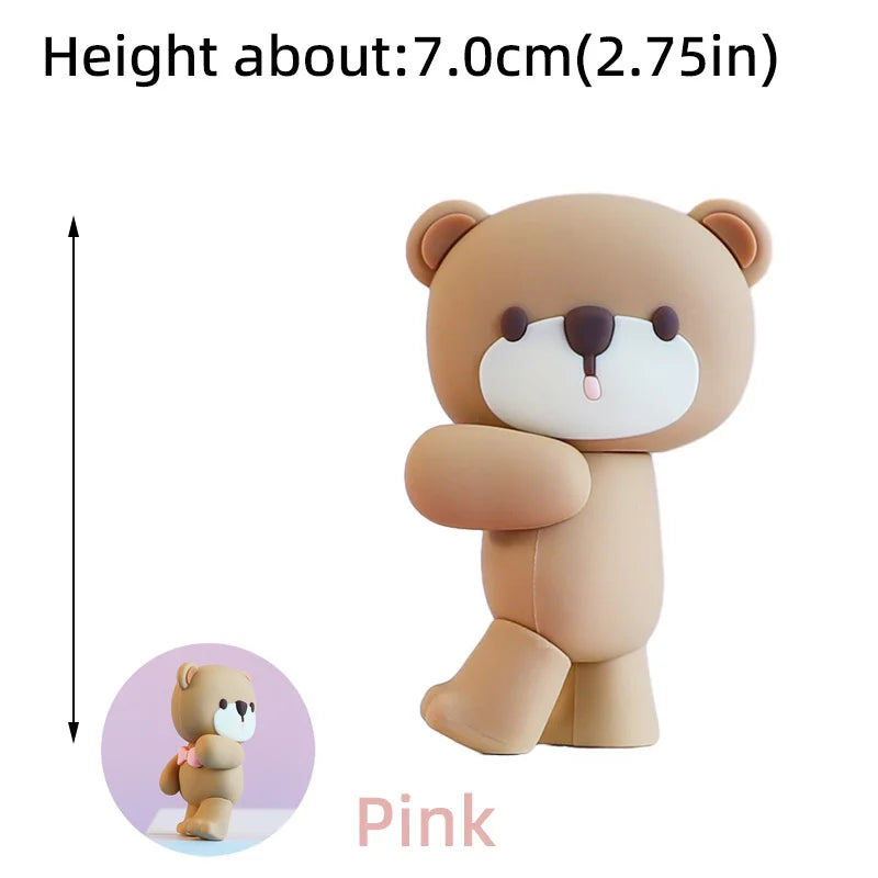A light brown pink bear cake topper with a white snout and pink accents.
