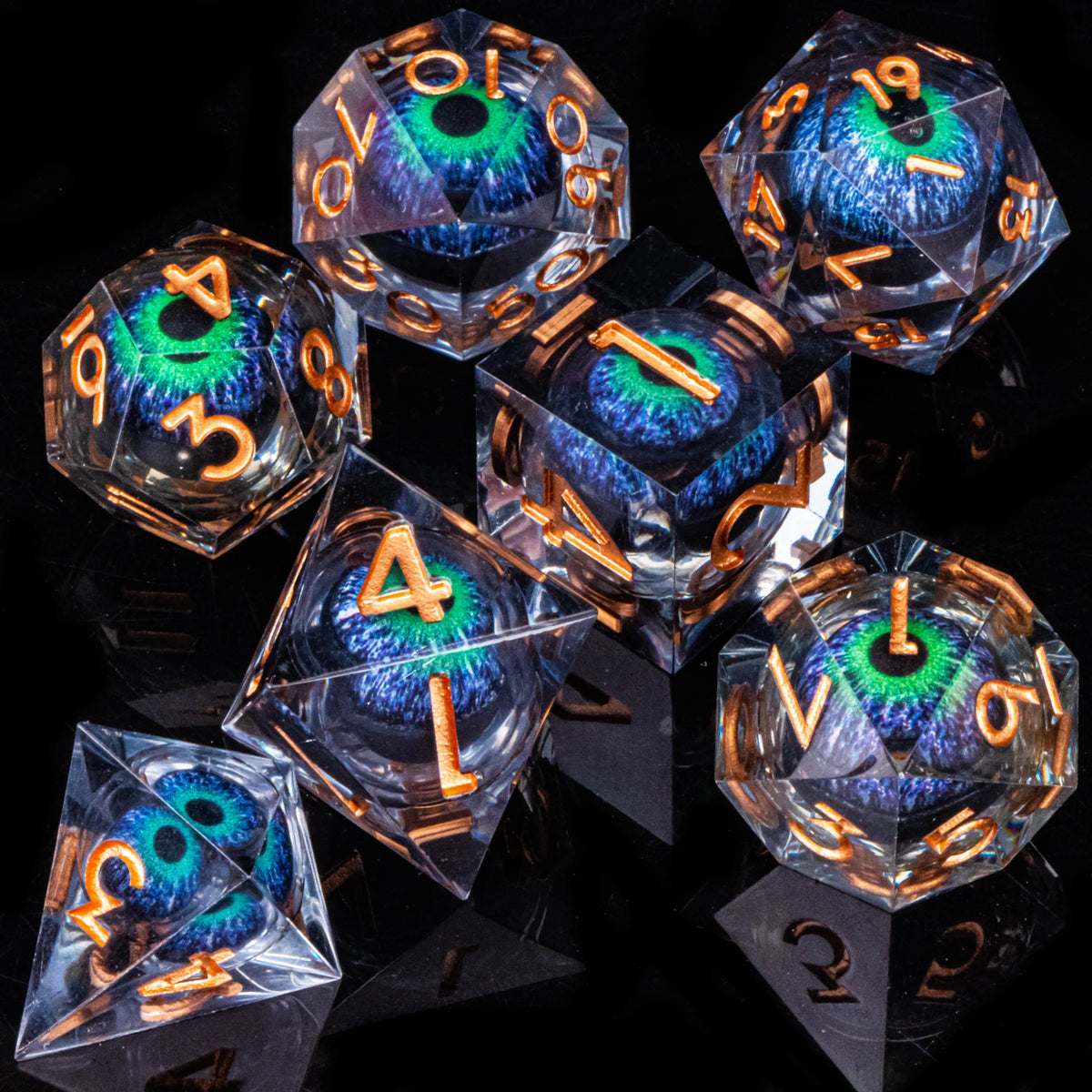 A collection of seven polyhedral resin dice with iridescent blue and green liquid core eyes set against a dark background.