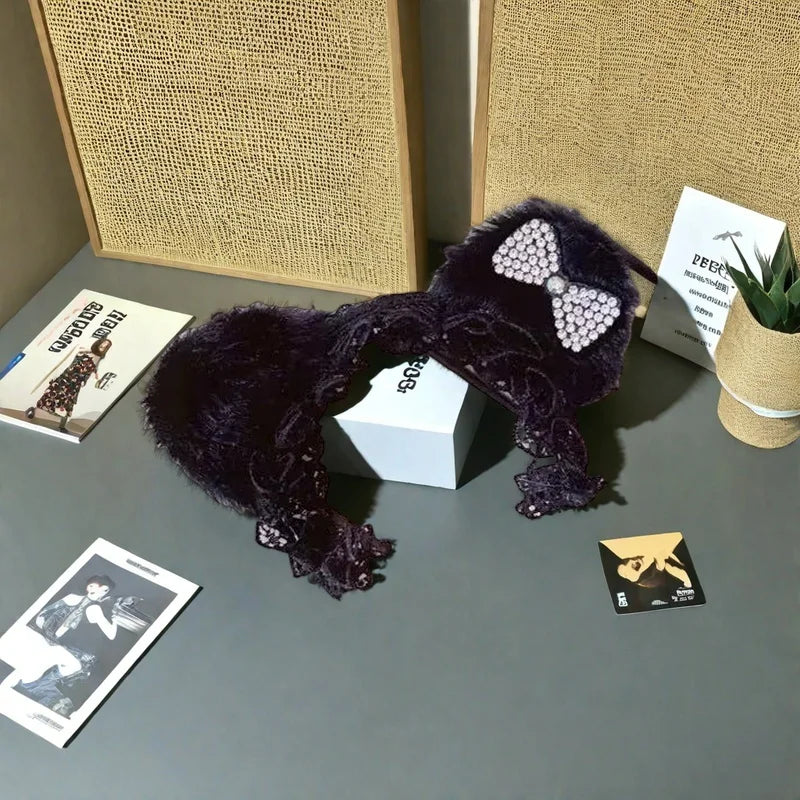 A dark purple leopard print sling dress for plush dolls displayed on a gray surface.