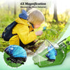 A child is using a handheld insect catcher with a quick-release mechanism to observe insects in nature.