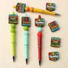 A set of colorful bingo-themed silicone beads and pens, including a yellow pen and various colored beads.