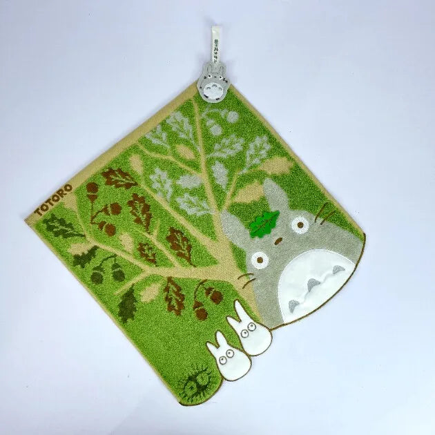 A soft stuffed animal featuring a cute white face and green body, with a small tag attached.