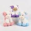 A collection of soft, cuddly cow plush toys in white and purple colors.