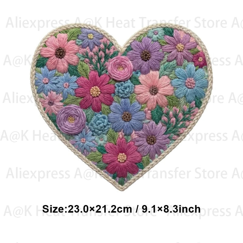 A heart-shaped patch featuring a dense floral design in shades of pink, purple, and blue.