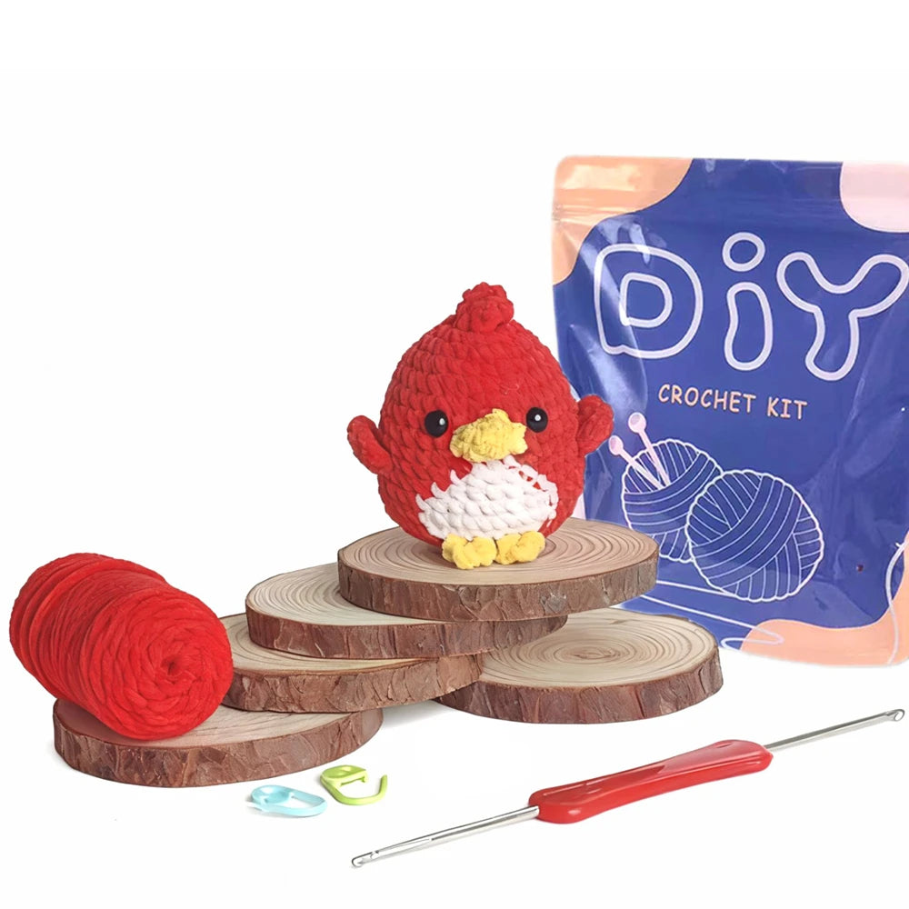 A DIY crochet kit featuring a red bird, yarn, and a crochet hook on a wooden surface.