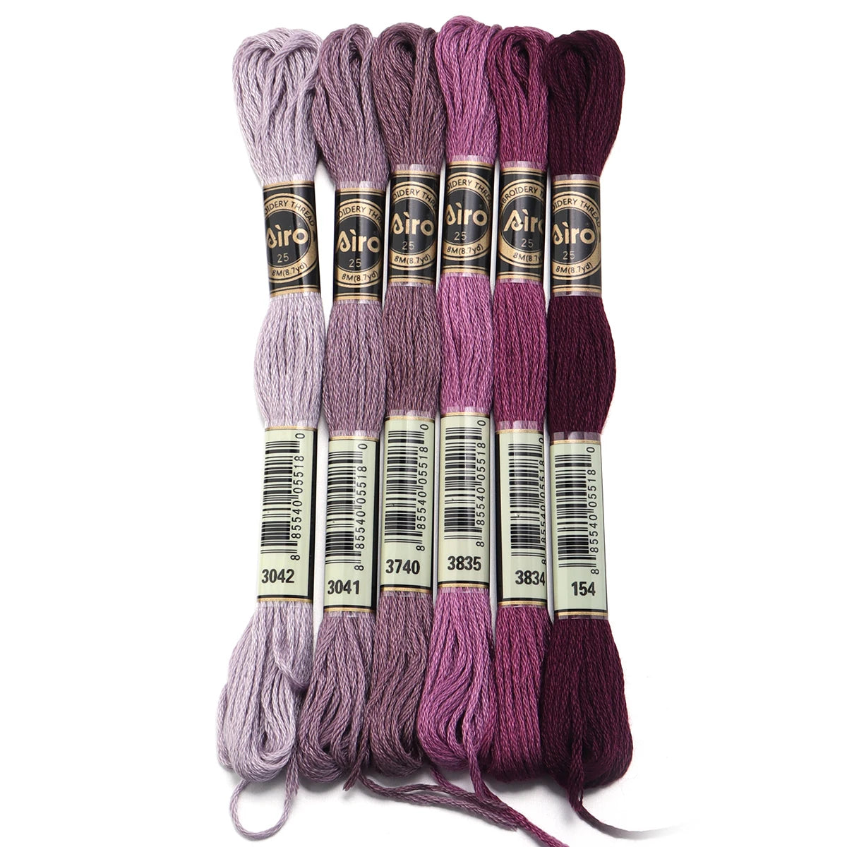A set of six skeins of vibrant embroidery thread in various shades of purple and magenta for cross stitch and DIY crafts