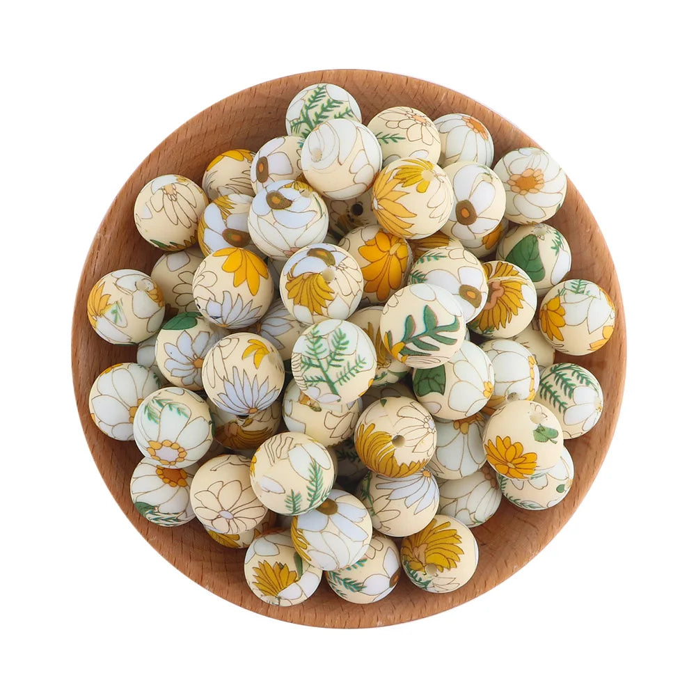 A wooden bowl filled with small, round, white and yellow patterned silicone beads for jewelry making.