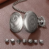 A silver steampunk dragon pocket watch and dice case with seven small dice resting on a brown textured surface.