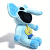A light blue plush doll resembling a cat with large ears and a black snout, holding a yellow lightbulb charm.