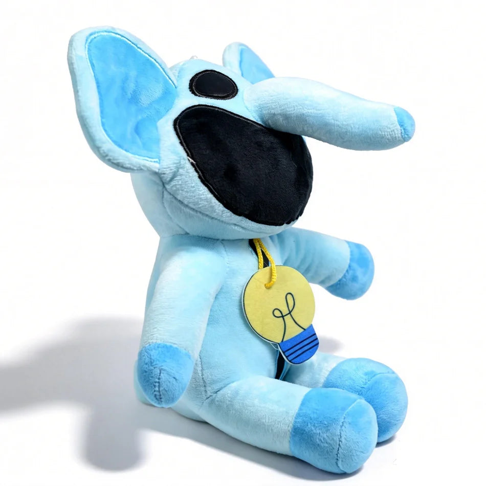 A light blue plush doll resembling a cat with large ears and a black snout, holding a yellow lightbulb charm.