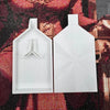 A pair of white diamond painting trays with pop-up plugs for bead sorting displayed on a dark background.