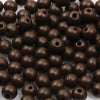 A pile of dark brown natural wooden beads for jewelry making and DIY crafts
