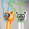 An orange cat toy and a white cat toy are shown, demonstrating the glow-in-the-dark rope launcher function.